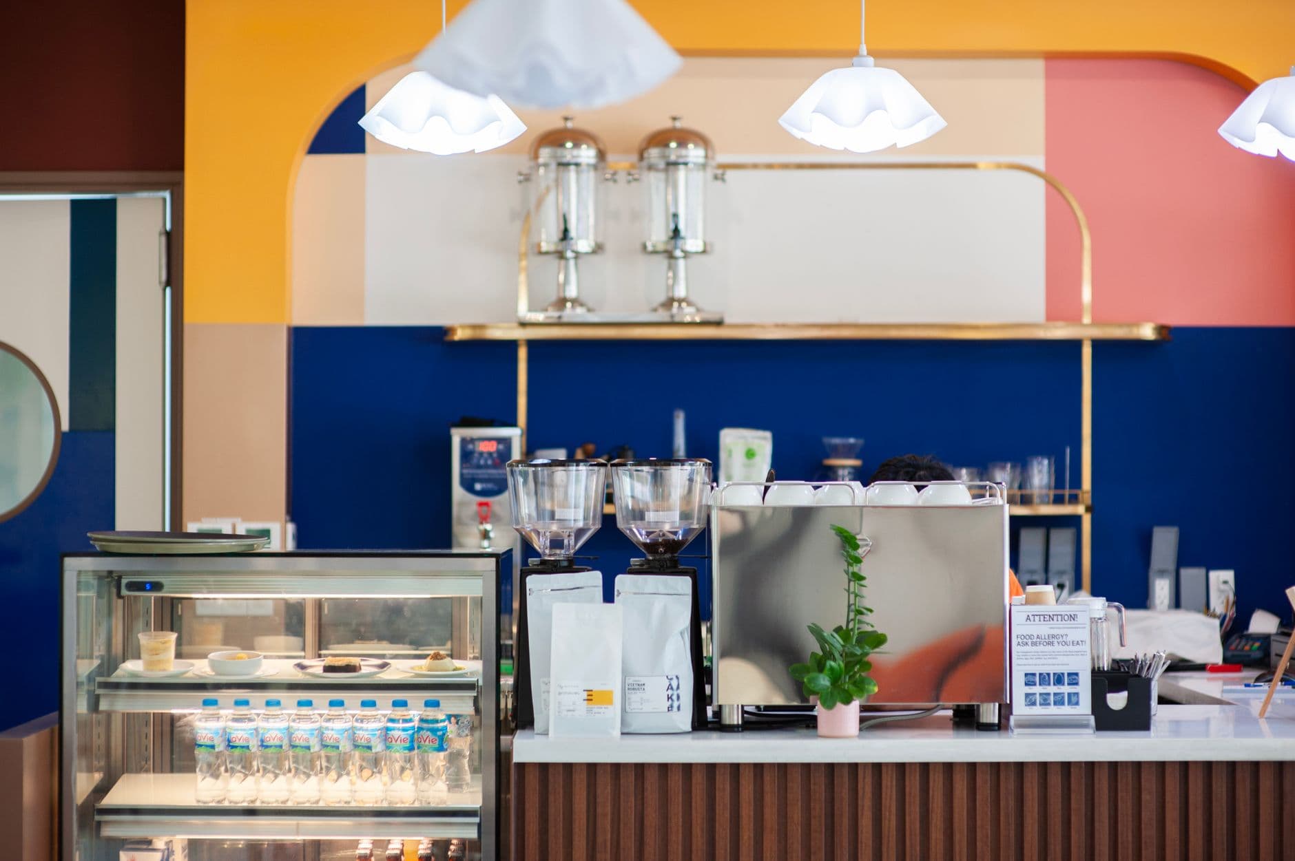 Modern cafe interior featuring stylish coffee bar and vibrant decor.
