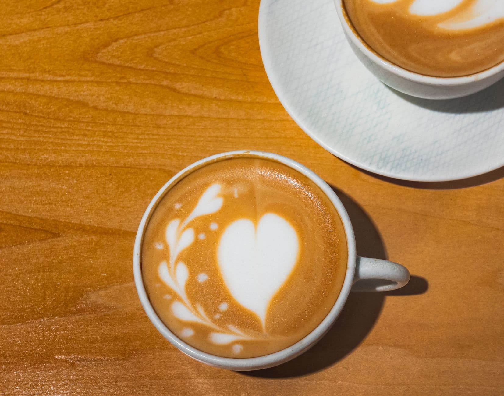 Close-up of heart-shaped latte art in a café, capturing the essence of Tokyo's coffee culture.