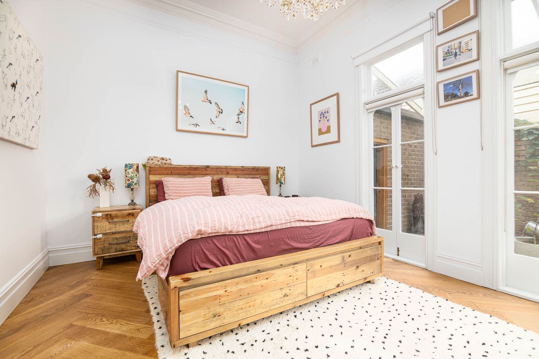 Bright and airy bedroom with rustic wood furniture, cozy decor, and natural light.