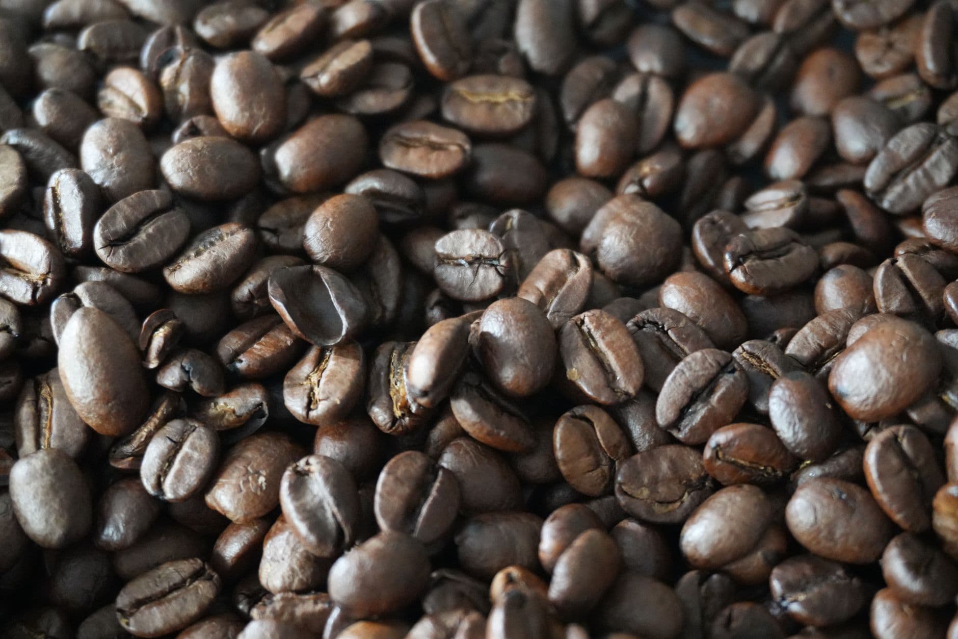 Detailed shot of aromatic roasted coffee beans, perfect for caffeine lovers.